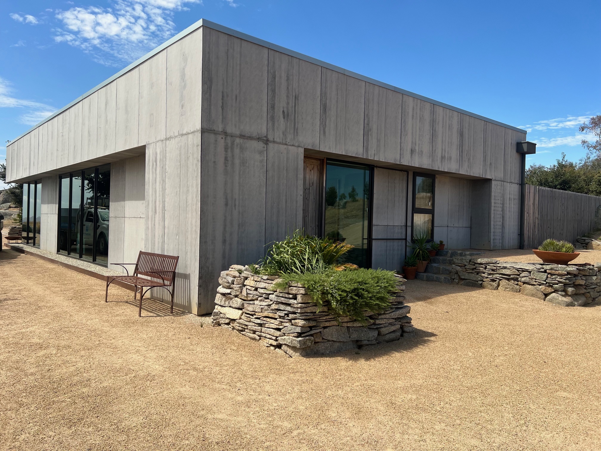 Concrete-clad home with large dark-framed glazing
