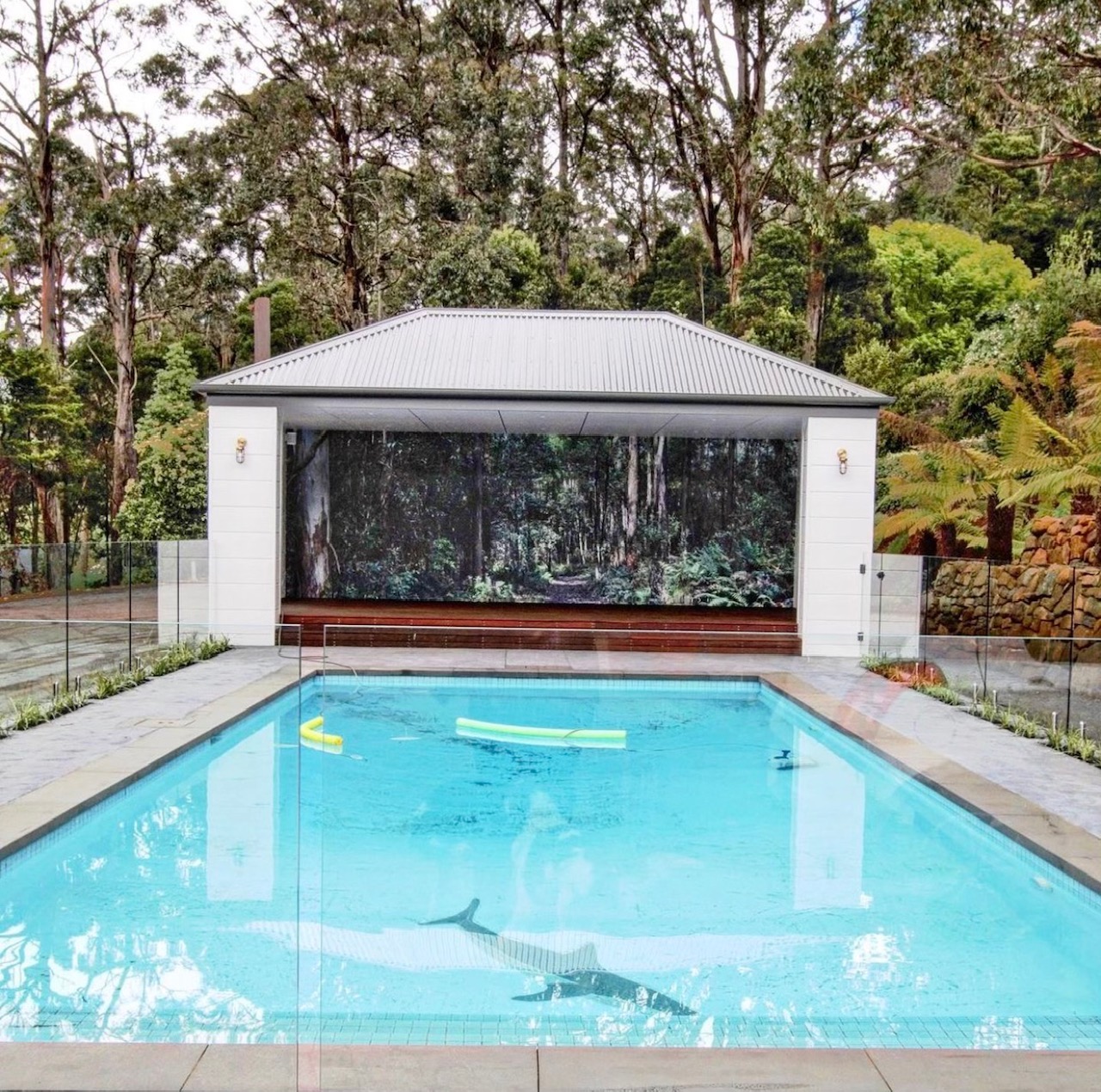 Frameless glass fence around pool and pavilion