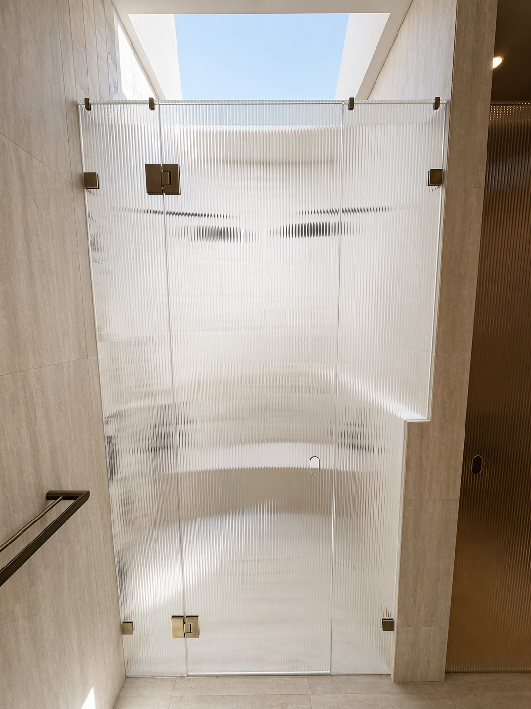 Fluted shower door and side panels beneath a large skylight