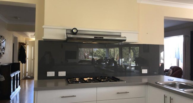 Dark kitchen glass splashback